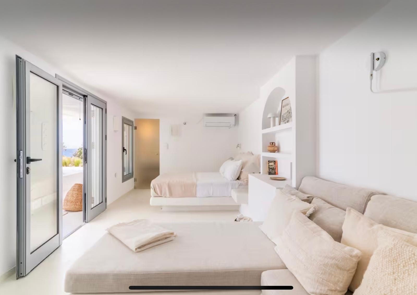 White bedroom suite opening to the terrace
